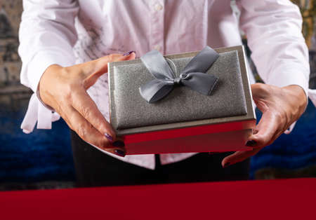 The girl opens the gift. The concept of the new year holiday.