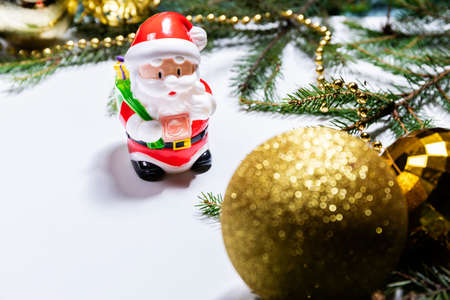 Christmas background with decorations and a toy Santa Claus.