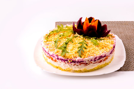 Salad herring under a fur coat with arugula leaves on a white plate.の写真素材