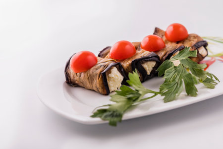 Eggplant rolls with cheese filling.ashew nuts in sesame seeds with honey on paper.の写真素材