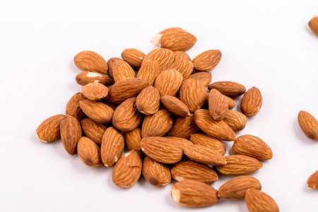 Almonds close up on a white background.の写真素材