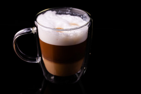Cappuccino coffee in a transparent cup close-up.の写真素材