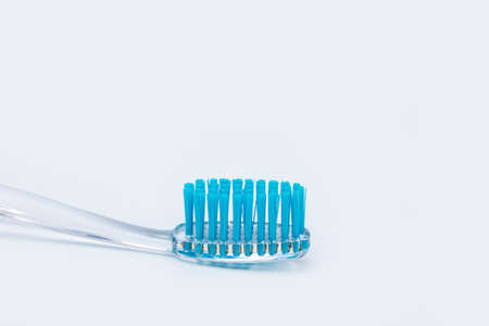The brush for dental care lies on the table on a white background.の写真素材