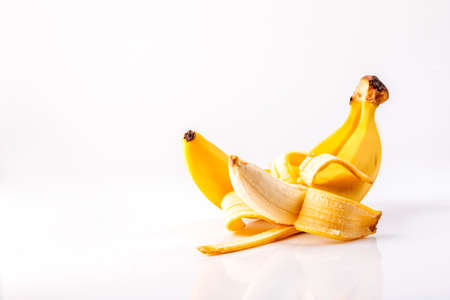 Two ripe bananas on a white table.の写真素材