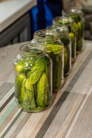 In glass jars, decomposed cucumbers for cooking canned food.の写真素材