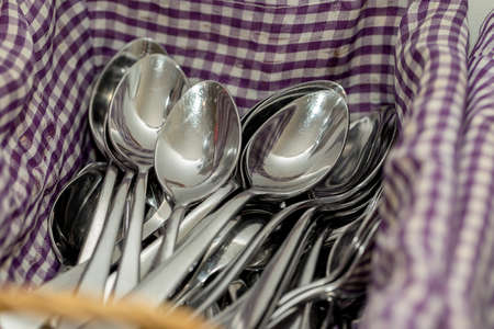 Clean spoons lie on a napkin in the kitchen.の写真素材