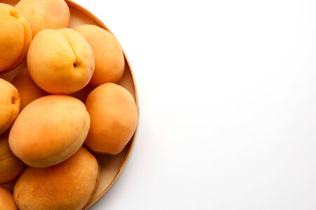 Isolated apricots. Fresh whole apricot fruit with leaf and half isolated on white backgroundの写真素材