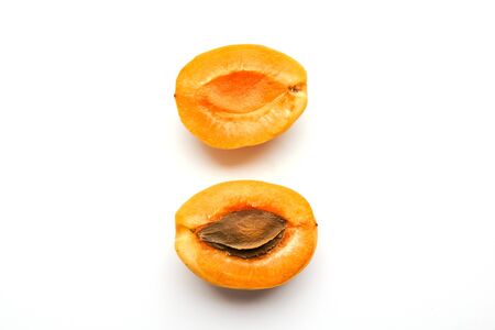 Isolated apricots. Fresh whole apricot fruit with leaf and half isolated on white background