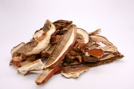 Dried white mushrooms on a white background. Dried porcini mushrooms.の写真素材