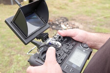 Skillful male freelancer is playing with a droneの写真素材