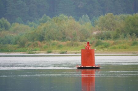 Red buoy - protects underwater obstacles and shows the border of the ship's passage.の写真素材