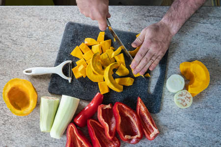 studio-shot of preparing lunch for the family. cooking hokkaido pumpkin soup in a modern kitchen.の写真素材