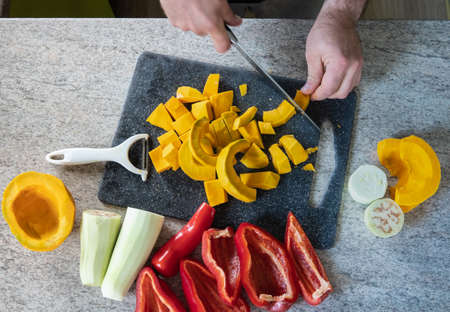 studio-shot of preparing lunch for the family. cooking hokkaido pumpkin soup in a modern kitchen.の写真素材