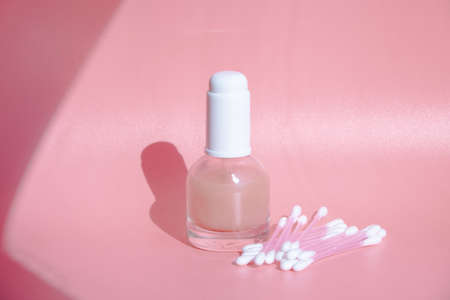 beautiful skin flat lay care pink serum liquid dropper minimal pink backgroundの写真素材