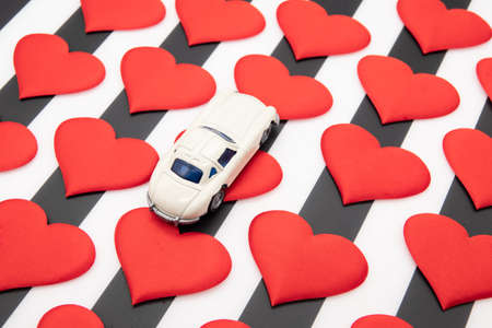 Valentines day red hearts on a black and white background car as a giftの写真素材