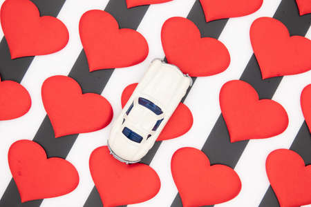 Valentines day red hearts on a black and white background car as a giftの写真素材