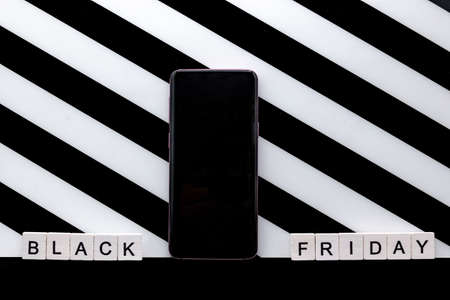 Shopping cart and black friday text on paper tear.