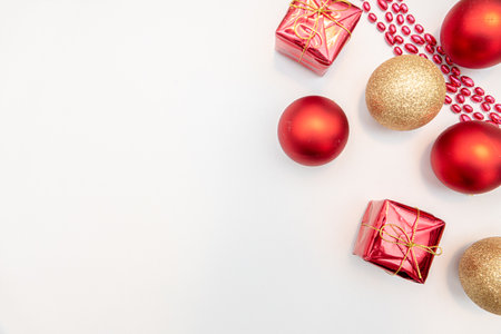 christmas gift with gold and red balls bow isolated on white backgroundの写真素材
