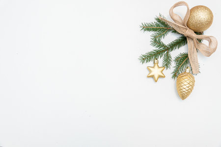 christmas gift with gold balls bow isolated on whiteの写真素材