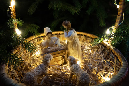 Baby Jesus resting on a manger with light from the starの写真素材