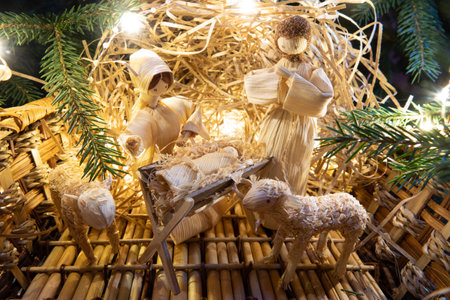 Baby Jesus resting on a manger with light from the starの写真素材