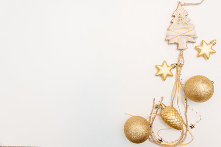 christmas gift with gold balls bow isolated on white backgroundの写真素材