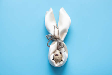 Blue Easter eggs and bouquet of flowers on blue table wood