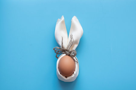 Blue Easter eggs and bouquet of flowers on blue table woodの写真素材