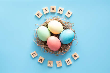 Easter eggs painted in pastel colors on blue. Easter conceptの写真素材