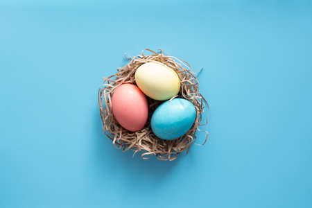 Easter eggs painted in pastel colors on blue. Easter conceptの写真素材