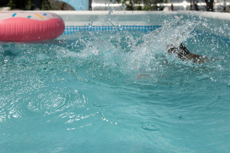 Swimming, summer vacation - lovely girl playing in blue water