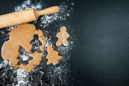 Children's hands make New Year's gingerbread cookies on a wooden table. New Year and Christmas concept.の写真素材