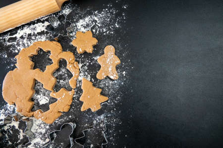 Children's hands make New Year's gingerbread cookies on a wooden table. New Year and Christmas concept.の写真素材