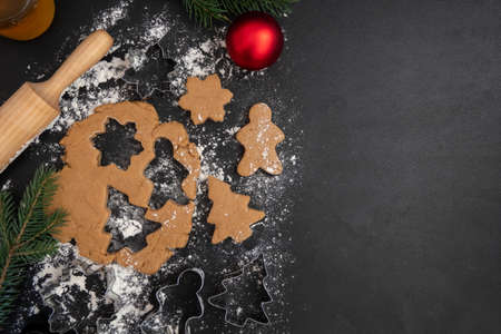 Children's hands make New Year's gingerbread cookies on a wooden table. New Year and Christmas concept.の写真素材