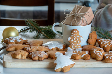 Happy New Year's set of gingerbread from ginger biscuits man glazed sugar icing decoration on black background, minimal seasonal pandemic winter holiday bannerの写真素材