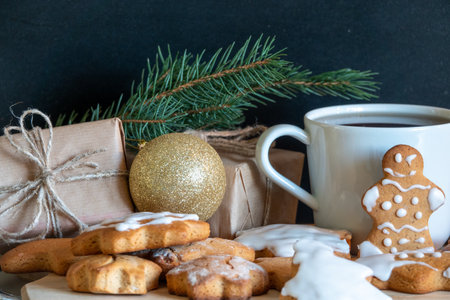 Happy New Year's set of gingerbread from ginger biscuits man glazed sugar icing decoration on black background, minimal seasonal pandemic winter holiday bannerの写真素材