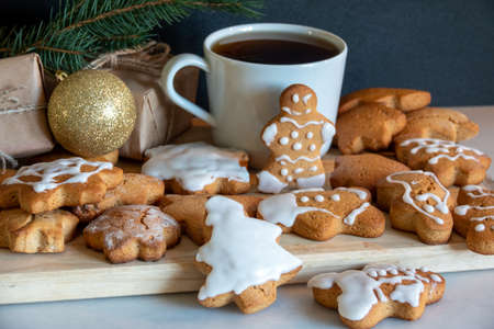Happy New Year's set of gingerbread from ginger biscuits man glazed sugar icing decoration on black background, minimal seasonal pandemic winter holiday bannerの写真素材