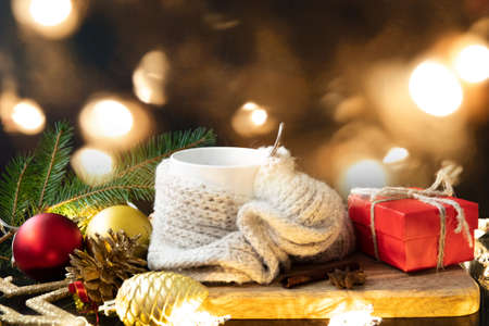 Cup of coffee with christmas decorations and box on dark wooden table.の写真素材