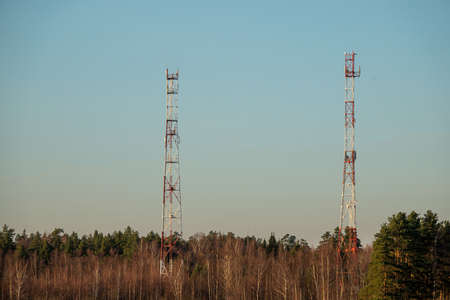 5G smart mobile telephone radio network antenna base station on the telecommunication mast radiating signalの写真素材