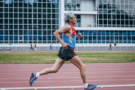Chelyabinsk, Russia - August 28, 2015:  old male athlete running during championship of Russia on track and field athletics among the elderly, Chelyabinsk, Russia - August 28, 2015のeditorial素材