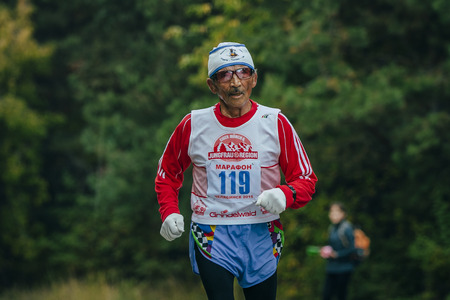 Chelyabinsk, Russia - September 6, 2015: elderly athlete runs through the Park during Chelyabinsk marathon, Chelyabinsk, Russia - September 6, 2015のeditorial素材