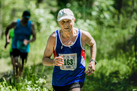 Miass, Russia - June 28, 2015: old man run during marathon "Running clean water-2015", Miass, Russia - June 28, 2015のeditorial素材