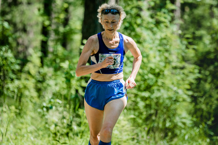 Miass, Russia - June 28, 2015: old woman run during marathon "Running clean water-2015", Miass, Russia - June 28, 2015のeditorial素材