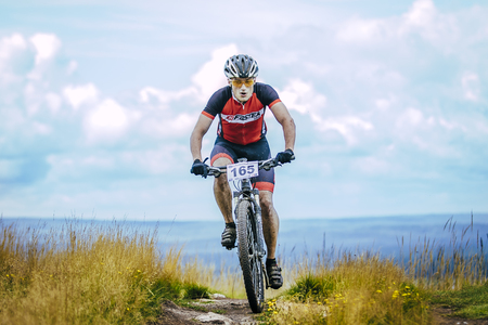 V.Ufaley, Russia - August 09, 2015: biker on the mountain top during race "Big stone", V.Ufaley, Russia - August 09, 2015のeditorial素材