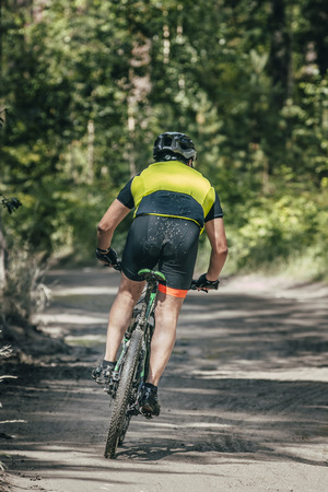 Mountainbiker rides race in forestの写真素材