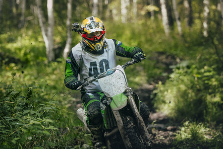 Sludorudnik, Russia - August 16, 2015:  rider overcomes mud puddle during "Urals Cup of Enduro", Sludorudnik, Russia - August 16, 2015のeditorial素材