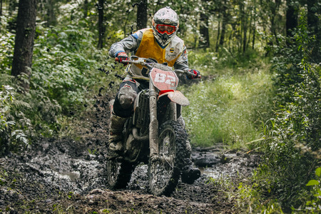 Sludorudnik, Russia - August 16, 2015:  racer Enduro overcomes mud puddle during "Urals Cup of Enduro", Sludorudnik, Russia - August 16, 2015のeditorial素材
