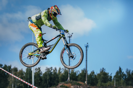Magnitogorsk, Russia -  September 12, 2015: racer on the mountain bike during the jump of the ski jumping against the sky during Urals Cup of downhill bike, Magnitogorsk, Russia -  September 12のeditorial素材