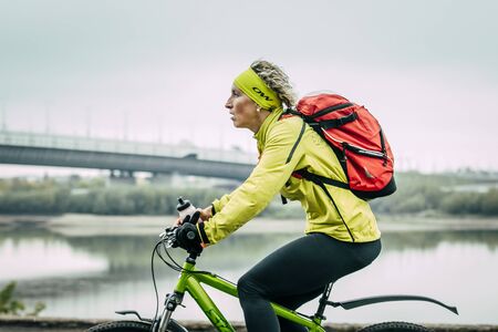 Omsk, Russia -  September 20, 2015: girl on bike rides along river during Siberian international marathonのeditorial素材