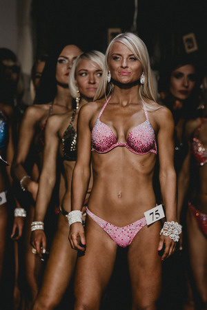 Chelyabinsk, Russia - October 3, 2015: athlete blonde fitness bikini stands ahead of all competitors during Championship of Chelyabinsk region on bodybuilding, bodyfitness and fitnessのeditorial素材